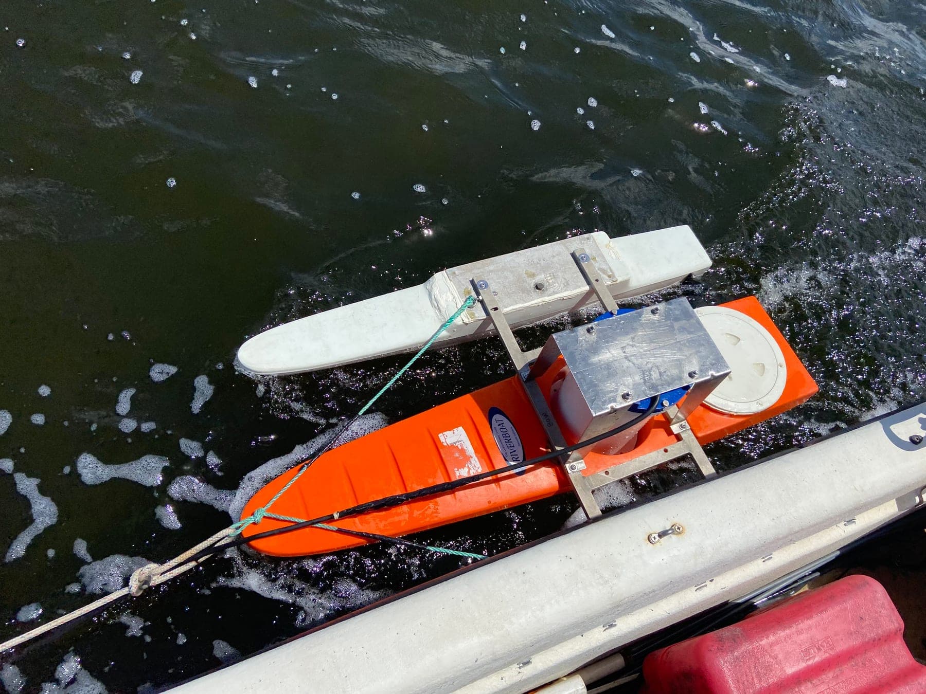 Towed ADCP rig used for repeated cross-sectional velocity measurements over ~20-hour tidal cycles to capture full flood and ebb flows through the pass.